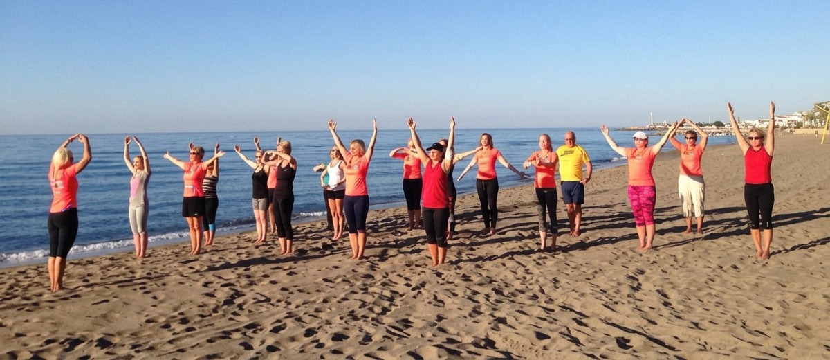 Grupp tränar utomhus på stranden med Träningsteam1 i Bålsta